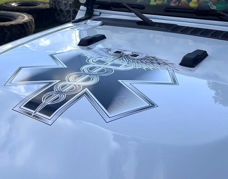 Custom hood graphics and blackout decal on a Jeep