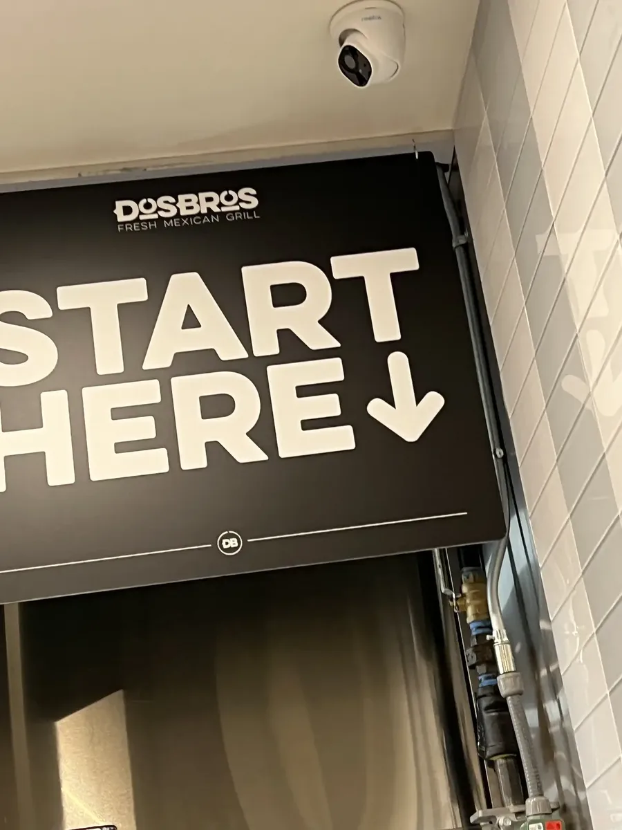 Overhead START HERE directional menu board sign in a restaurant order line, Shelbyville, TN