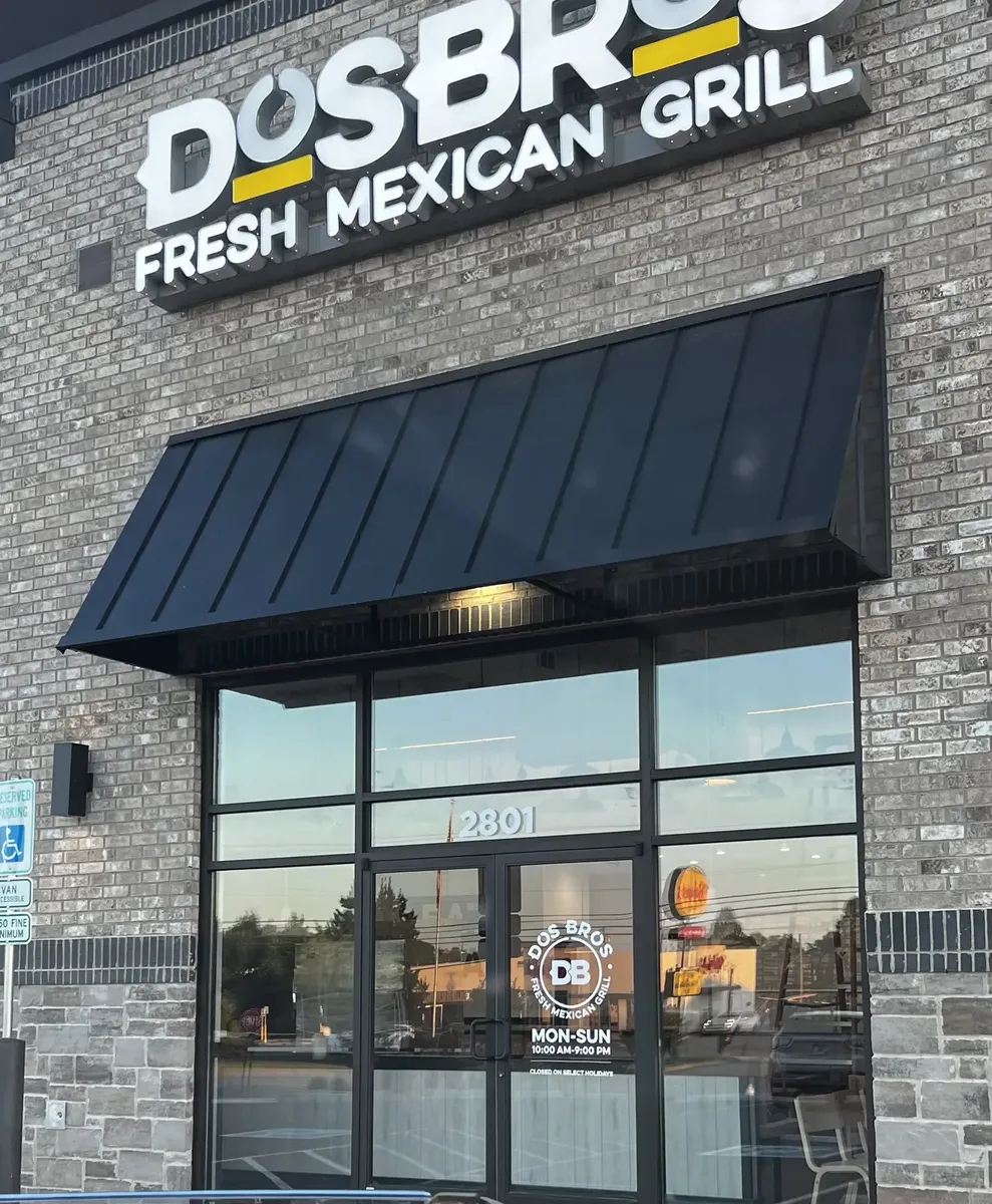 Storefront sign installed by Smiles and Signs