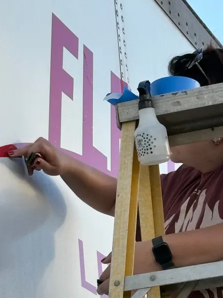Vinyl trailer lettering being squeegeed down and the tape peeled away by Smiles and Signs (4 of 4)