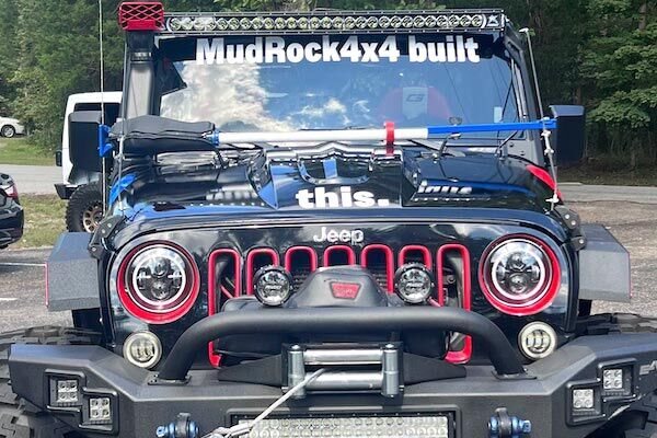 Custom windshield decal on a lifted Jeep