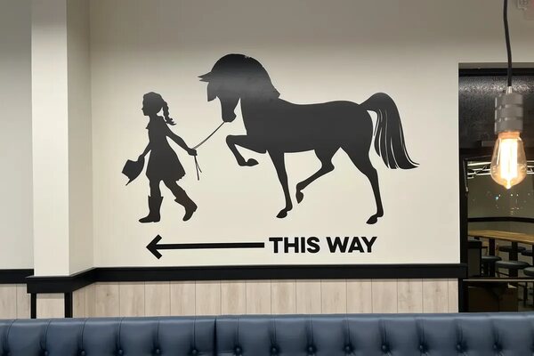 Wall mural and wayfinding graphic installed in a restaurant dining room