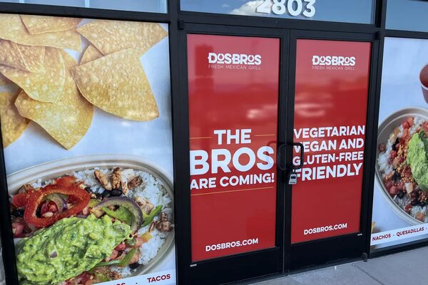 Full storefront window graphics installed on a restaurant build-out