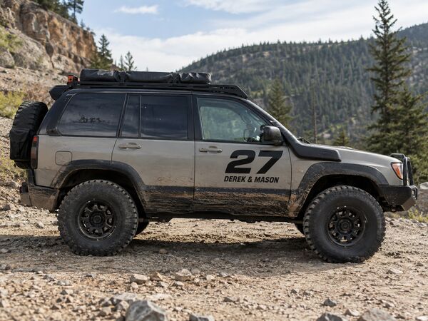 Off-road SUV with race-style number 27 and driver names cut in vinyl on the front door