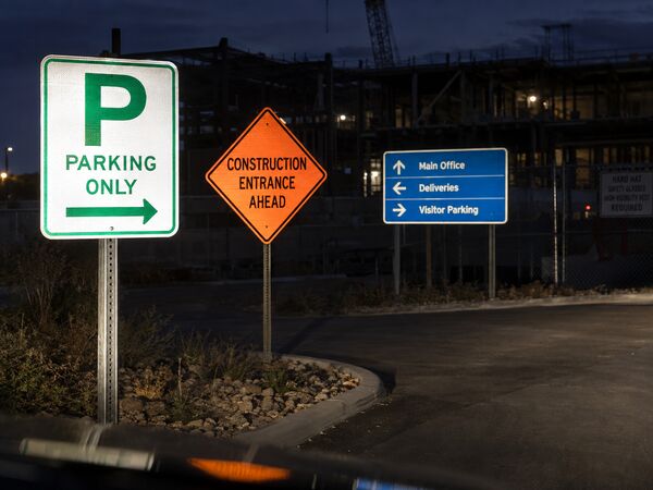 Reflective parking, construction and wayfinding signs lit by headlights at night