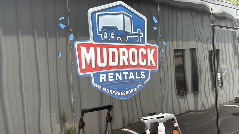 MudRock Rentals logo decal applied to a black enclosed cargo trailer in Murfreesboro TN