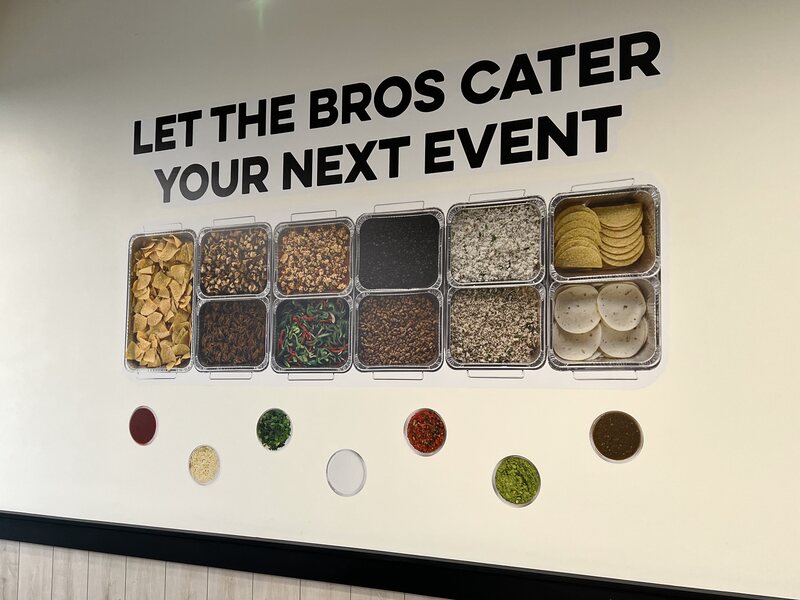 Finished interior wall graphic with dimensional lettering and product display