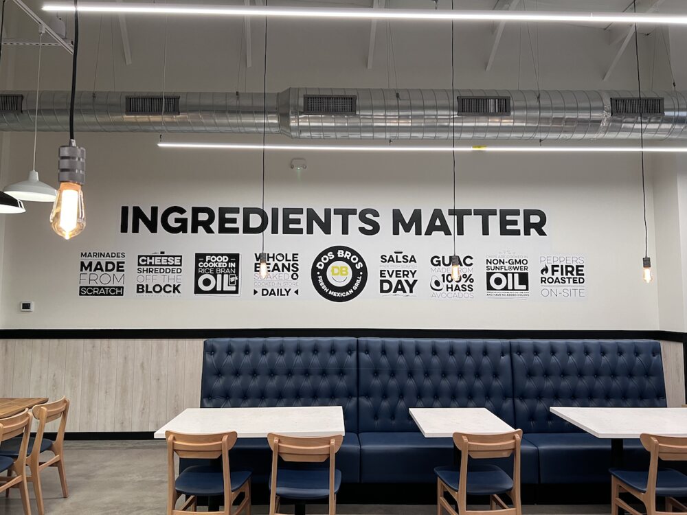 INGREDIENTS MATTER cut vinyl wall graphic above the booth seating in the finished dining room of a Dos Bros Mexican Grill restaurant in Middle Tennessee